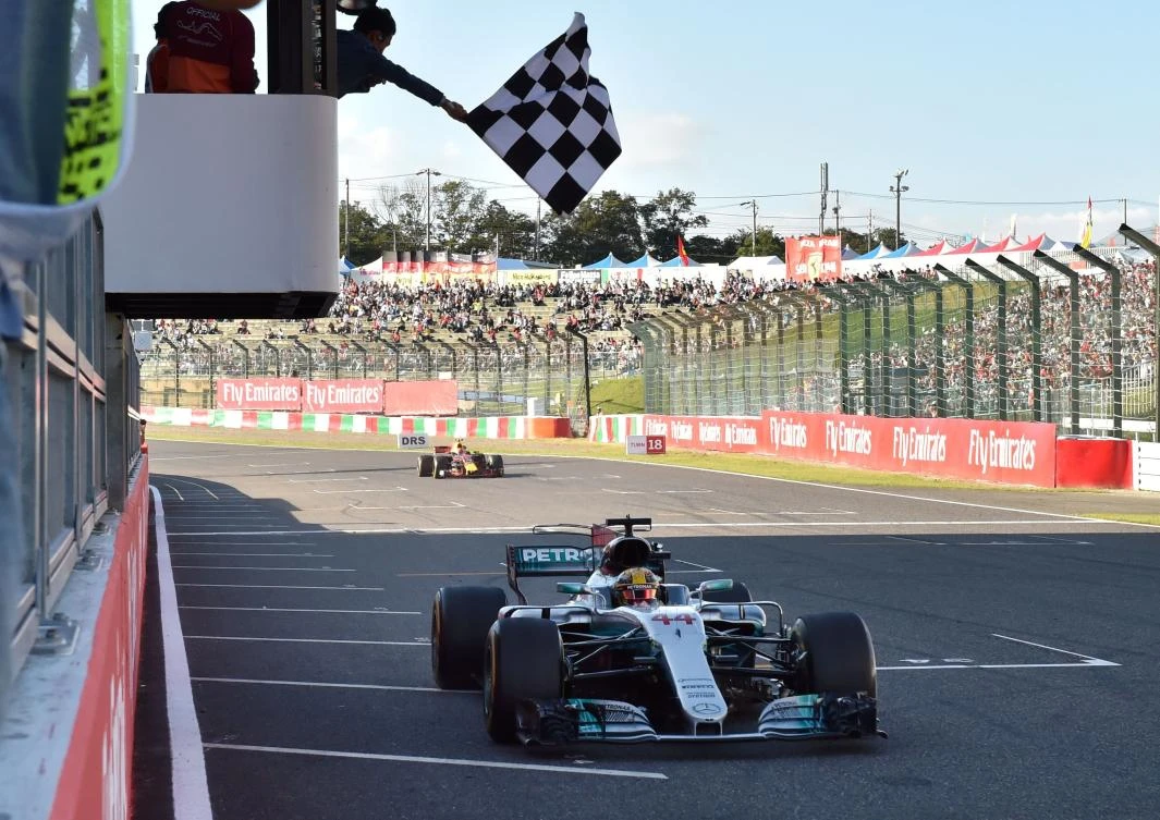 Mercedes’ British driver Lewis Hamilton crosses the finish line to win the Formula One Japanese Grand Prix at Suzuka. (AFP)