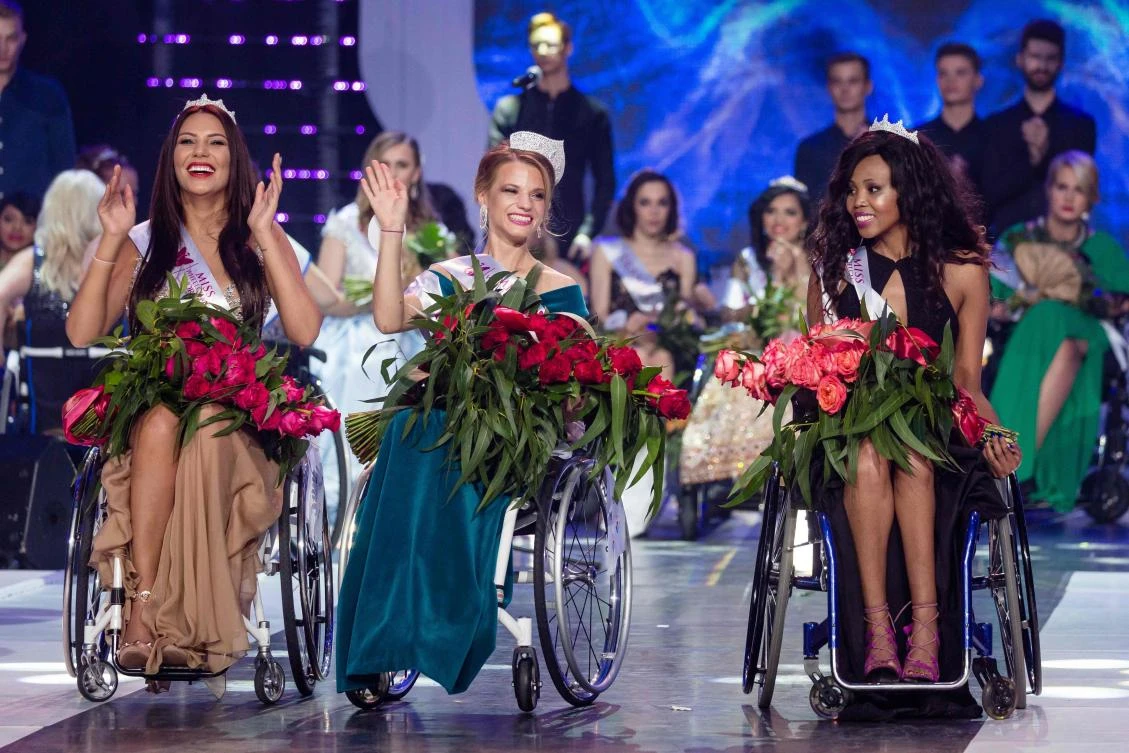 Miss Belarus Aleksandra Chichikova, center, winner of the Miss Wheelchair World, first runner-up Lebohang Monyatsi from South Africa, right, and second runner-up Adriana Zawadzinska of Poland celebrate after being crowned in the inaugural handicapped beauty pageant. (AFP)