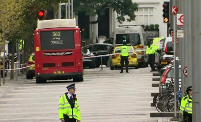 Police officers surround the scene of an incident involving a car in central London, Saturday. (AP)