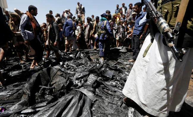People gather at the site of the wreckage of a drone aircraft which the Houthi rebels said they have downed in Sanaa, Yemen on October 1, 2017. (Reuters)