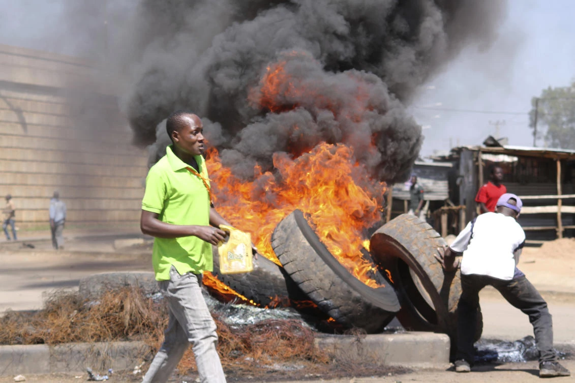 Nsa (National Super Alliance) supporters burn tires on the street of Kisumu, Kenya, Monday Oct. 2, 2017. Kenyan police lobbed tear gas and fired shots in the air in Nairobi and Kisumu Monday to disperse protesters who are demanding a change of leadership at the country's election commission. (AP)