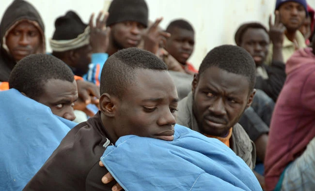 In this file photo, Illegal migrants sit upon their arrival in the southeastern Tunisian port city of Zarzis on April 25, 2015. (AFP)