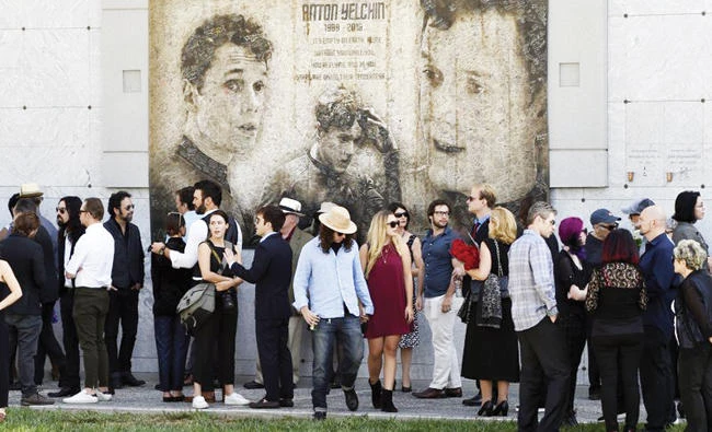 Guests gather beneath a mural of the late actor Anton Yelchin created by fans at a ‘Star Trek’ convention, in Los Angeles. (AP)