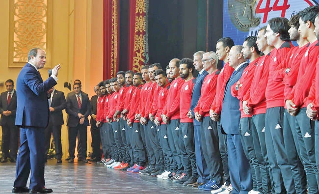 A handout picture released by the Egyptian Presidency on Monday shows Egyptian President Abdel Fattah El-Sisi honoring players of his country’s national football team following their win over Congo and securing a place at the 2018 World Cup in Russia. (AFP)