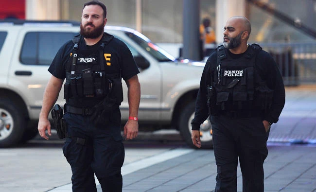 Houston police patrol the downtown area as the first days curfew ends after Hurricane Harvey caused heavy flooding in Houston, Texas, in this August 30, 2017 photo. (AFP)
