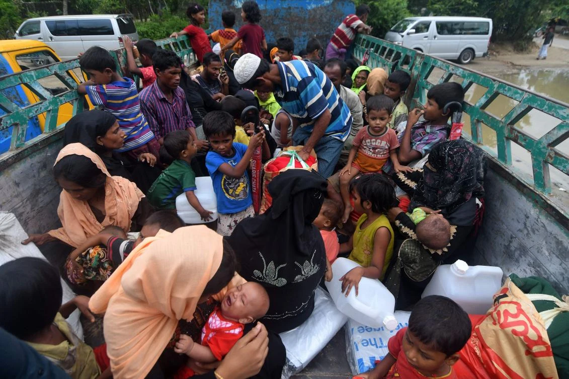 Rohingya refugees are seen atop a truck before being shift to a refugee camp following their arrival after crossing the border from Myanmar into Bangladesh in Teknaf on Oct. 7, 2017. (AFP/Munir Uz Zaman)