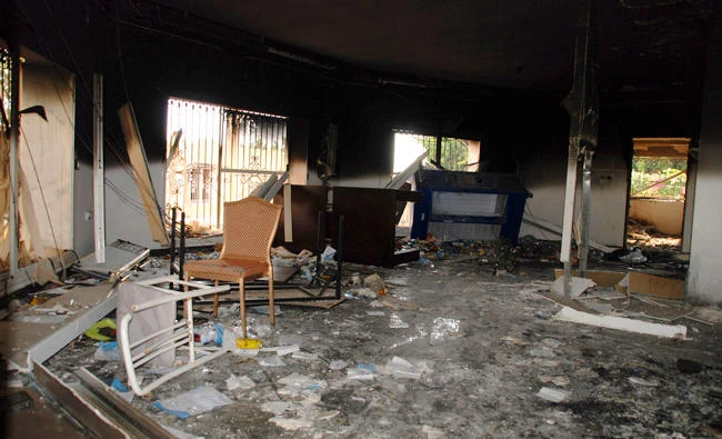 In this file photo, Glass, debris and overturned furniture are strewn inside a room in the gutted U.S. consulate in Benghazi, Libya, after an attack that killed four Americans, including US Ambassador to Libya Christopher Stevens. The trial of Ahmed Abu Khattala, the suspected mastermind of the 2012 Benghazi, Libya, attacks will be one of the biggest terrorism cases yet for the U.S. Justice Department under a leader who has said it shouldn't be handling such cases. (AP)