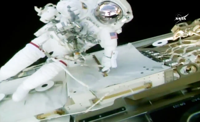 In this image from video made available by NASA, astronaut Randy Bresnik performs a spacewalk with Mark Vande Hei, not pictured, outside the International Space Station on Tuesday. (AP)
