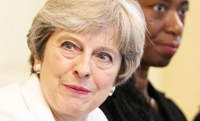 Britain's Prime Minister, Theresa May, hosts a discussion around the cabinet table on the findings of the Race Disparity Unit, in 10 Downing Street, central London, Britain on Tuesday. (REUTERS)