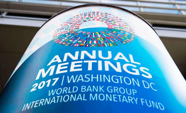 A placard announcing the 2017 Annual Meetings adorn the World Bank Headquarters in Washington, DC, on Monday. (AFP)