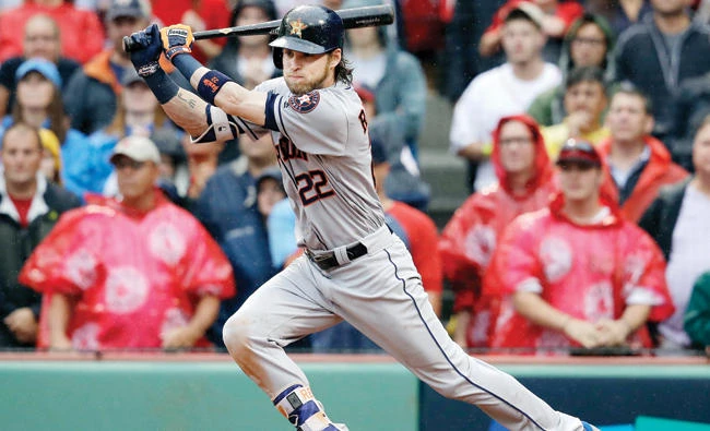 Houston Astros right fielder Josh Reddick hits an RBI single to drive in Cameron Maybin during the eighth inning in Game 4 of baseball’s American League Division Series against the Boston Red Sox Monday in Boston. (AP)