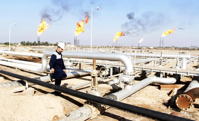 A worker walks at Nahr Bin Umar oil field, north of Basra, Iraq, in this December 21, 2015 file photo. (REUTERS)