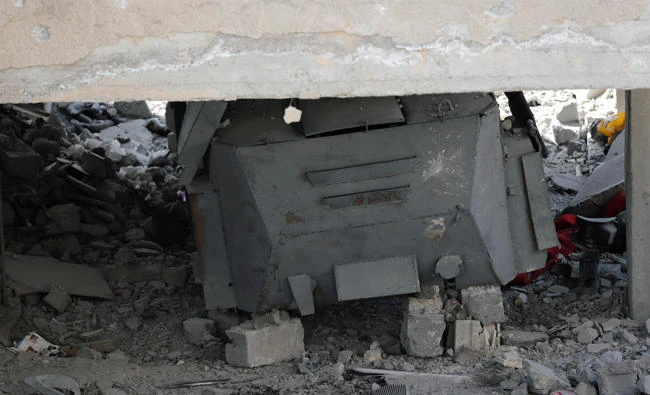A suicide armoured vehicle of the Daesh militants is pictured under the rubble of a building at the frontline in Raqqa, Syria on October 7, 2017. (Reuters)