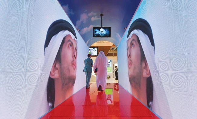 A model of a new security tunnel at the Gitex 2017 exhibition that will allow passengers departing Dubai to avoid security delays as their face and iris are scanned using 80 hidden cameras. A new report from PwC points to an improving outlook for the UAE economy next year. (AFP)