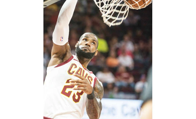 Cleveland Cavaliers' LeBron James dunks against the Chicago Bulls during the first half of an NBA preseason basketball game in Cleveland Tuesday. (AP)