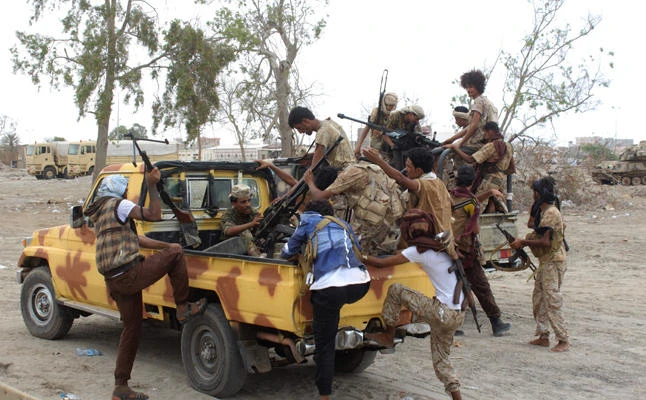 Pro-government fighters are seen outside a military camp near airport in the southern Yemeni city of Aden in this file photo. Security forces have arrested 10 members of an Islamist partner in the internationally-recognized government, increasing tensions, the Islah party said on Wednesday. (AFP file photo)