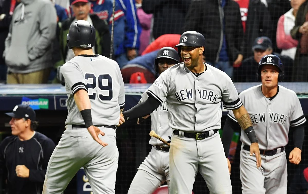 The New York Yankees celebrate after Todd Frazier (#29) scored on a single by Brett Gardner (#11) in the ninth inning against the Cleveland Indians in Game Five of the American League Divisional Series. (AFP)