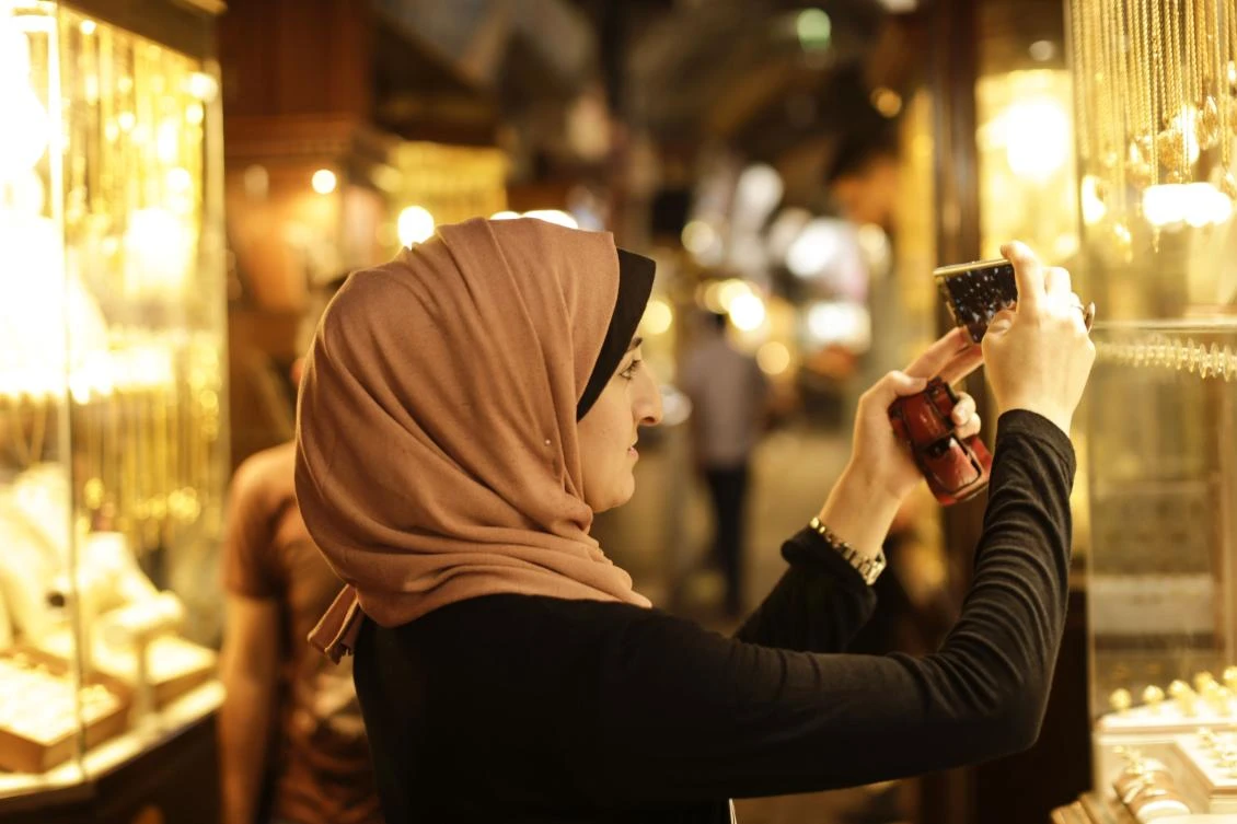 Palestinian Kholoud Nassar, 26, uses her mobile phone to take pictures for her social media account in Deir Al-Balah in the central Gaza strip. (AFP)