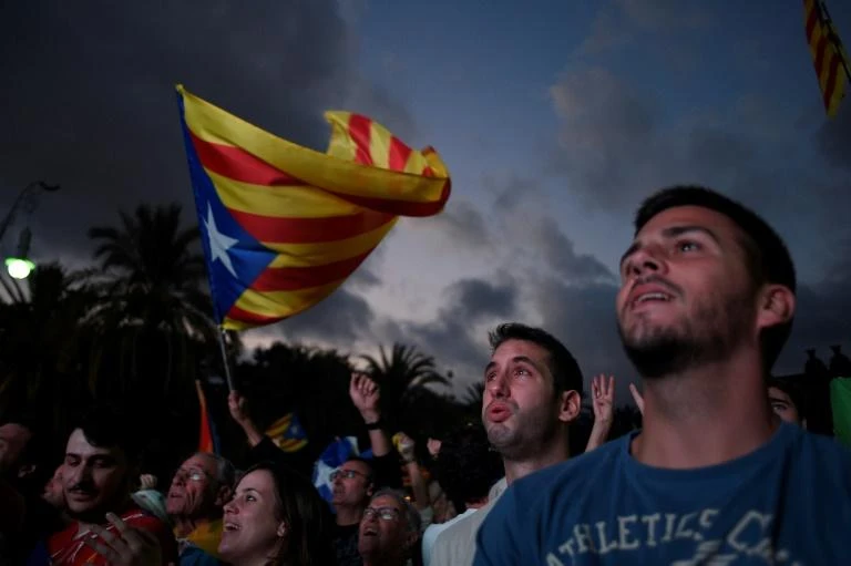 Catalan leader Carles Puigdemont's speech to parliament was watched by crowds on a television screen in Barcelona. (AFP)