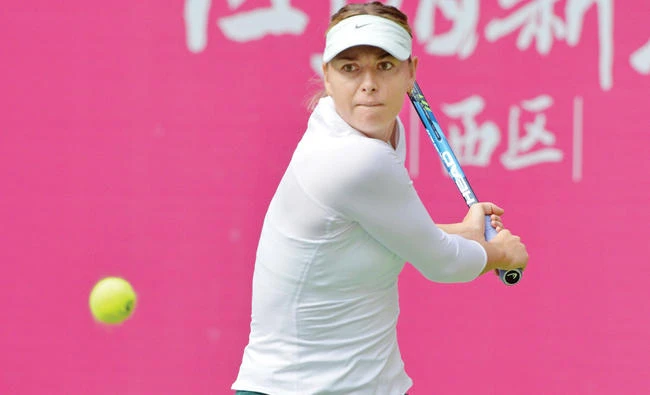 Maria Sharapova of Russia hits a return against Magda Linette of Poland during their women’s singles second round match at the WTA Tianjin Open tennis tournament in Tianjin on Thursday. (AFP)