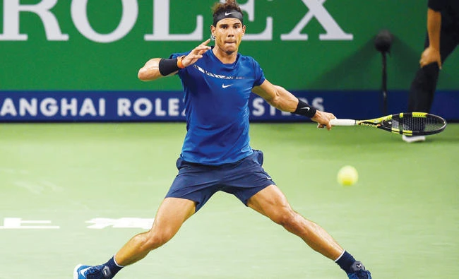 Rafael Nadal of Spain hits a return during his men’s third round singles match against Fabio Fognini of Italy at the Shanghai Masters tennis tournament in Shanghai on Thursday. (AFP)