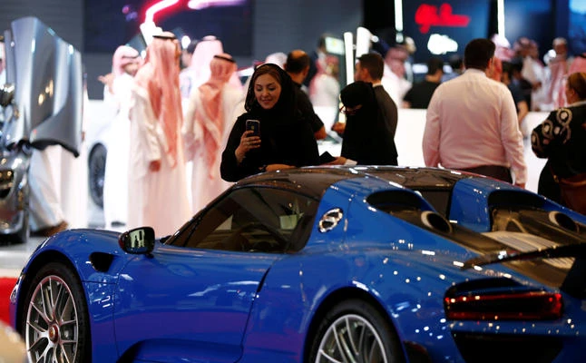 A Saudi woman takes pictures at a car showroom in Riyadh on October 5, 2017. Saudi women will now be allowed to drive cars under a decree issued last month by King Salman. (REUTERS/Faisal Al Nasser)