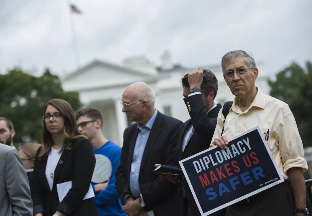 A man holds up a sign during a protest calling for the Trump administration to continue diplomacy with Iran near the White House in Washington, D.C.m on October 12, 2017. Trump is set to deal a blow to the Iran nuclear deal, which the European Union is desperate to uphold. (AFP)