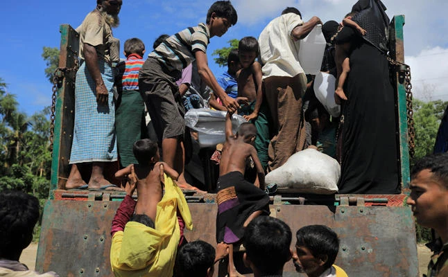 Rohingya refugees who arrived from Myanmar get onto a truck that will take them to a refugee camp from a relief center in Teknaf, near Cox's Bazar in Bangladesh, on Friday, October 13, 2017. (REUTERS/Zohra Bensemra)