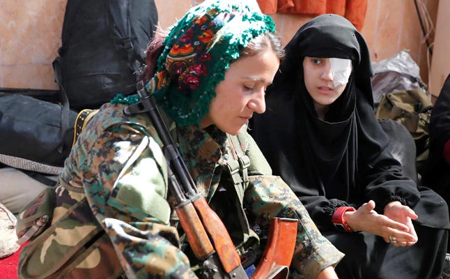 A civilian who got wounded by an airstrike at Raqqa’s front line talks to a fighter of Syrian Democratic Forces (SDF) at a mosque in Raqqa on Thursday. (Reuters)