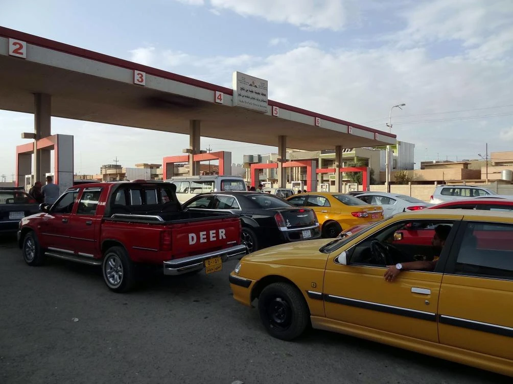 Iraqis queue outside a petrol station in Kirkuk. Iraqi federal forces plan to restore the central government’s control of the city’s oil fields (AFP)