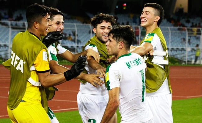 Iraq's reserve players congratulate Mohammed Dawood for scoring a goal against Chile during the FIFA U-17 World Cup match in Kolkata, India, on Wednesday. (AP)