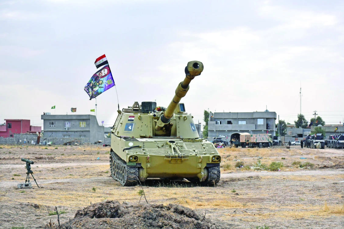 An Iraqi tank is parked near a former Kurdish military position in the northern Iraqi town of Tuz Khurmatu, near Kirkuk. (AFP)