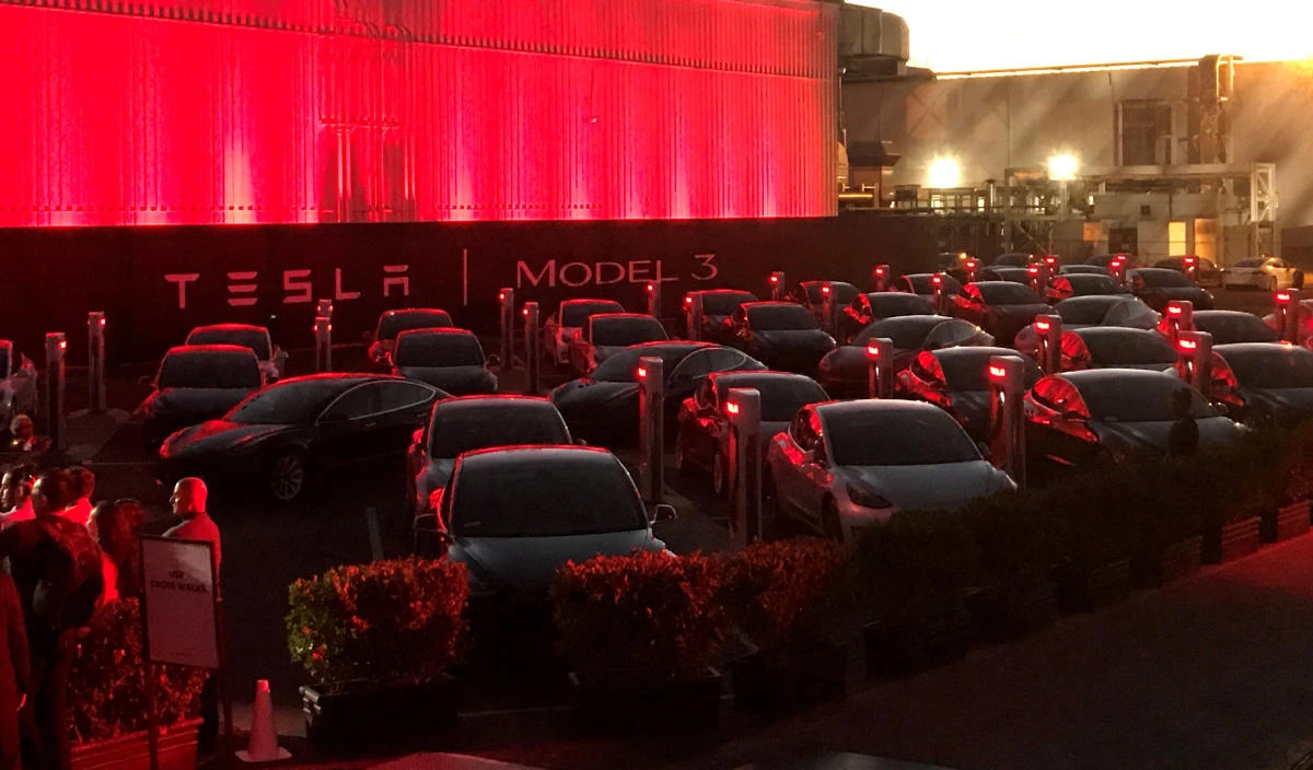 Above, Tesla Model 3 cars wait for their new owners as they come off the carmaker’s production line during an event at its facilities in Fremont, California in July. (Reuters)