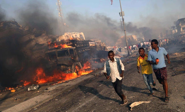 Civilians evacuate from the scene of an explosion in KM4 street in the Hodan district of Mogadishu on Saturday. (Reuters)