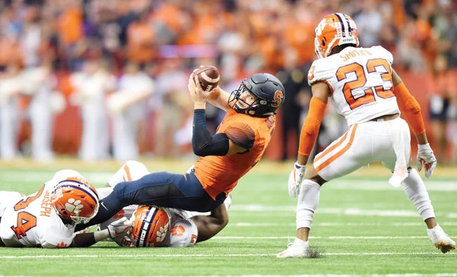 Syracuse Orange quarterback Eric Dungey reaches for a first down in front of Clemson Tigers safety Van Smith (23) during the fourth quarter at the Carrier Dome on Friday. (USA TODAY Sports)