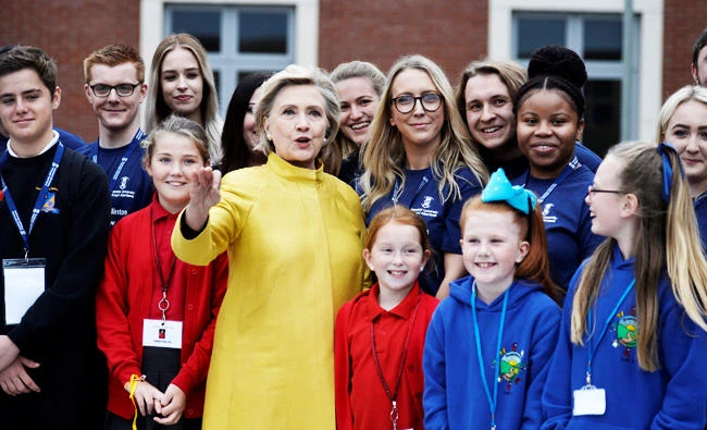 Former U.S. Secretary of State, Hillary Clinton, poses for a photograph with local schoolchildren at Swansea University after receiving an honorary degree, in Swansea, Britain on Saturday. (REUTERS)