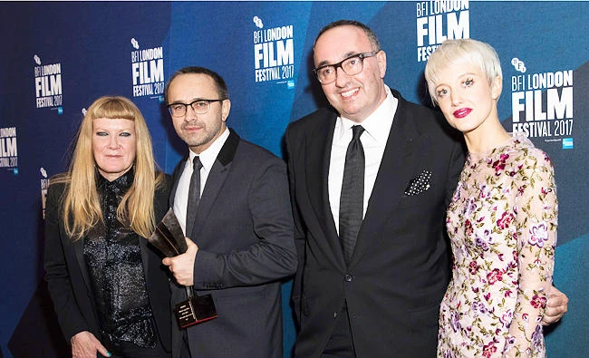 Directors Andrey Zvyagintsev, second left and Alexander Rodnyansky, second right, pose for photographers along with director Andrea Arnold, left, and actress Andrea Riseborough, right, after they received the Official Competition Best Film award for their film 'Loveless' at the London Film Festival Awards in London, on Saturday. (AP)