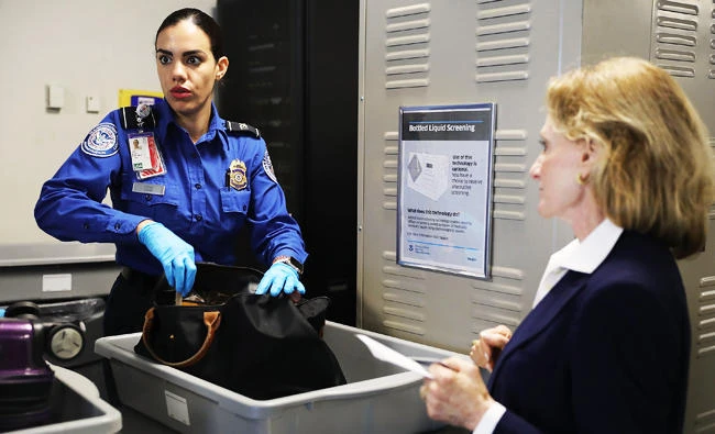 A Transportation Security Administration (TSA) worker screens luggage at LaGuardia Airport (LGA), in this September 26, 2017 in New York City photo. (AFP)