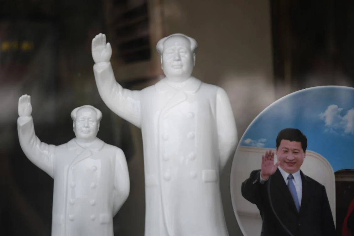Above, a plate features a portrait of China’s President Xi Jinping, right, next to statues of late communist leader Mao Zedong, at a stall in the “East is Red Square,” in Nanjie village, in China’s central Henan province. (AFP)
