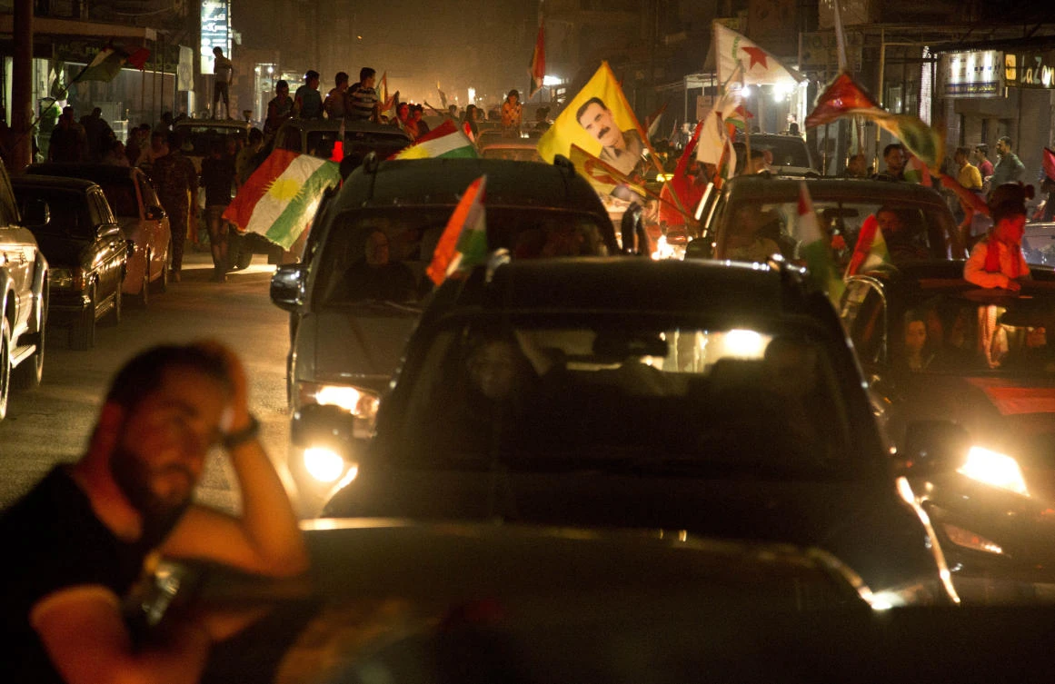 In this picture taken on September 25, 2017 and provided by Rojava Photo, Syrian Kurds citizens wave their parties and Kurdistan flags as they tour by their cars celebrating after the Iraqi Kurds in Erbil held the independence referendum, in Qamishli, north Syria. While Iraq’s Kurds have sparked confrontation with their drive for independence, Kurds in Syria are making major advances toward their more modest goal, entrenching their self-rule.(AP)