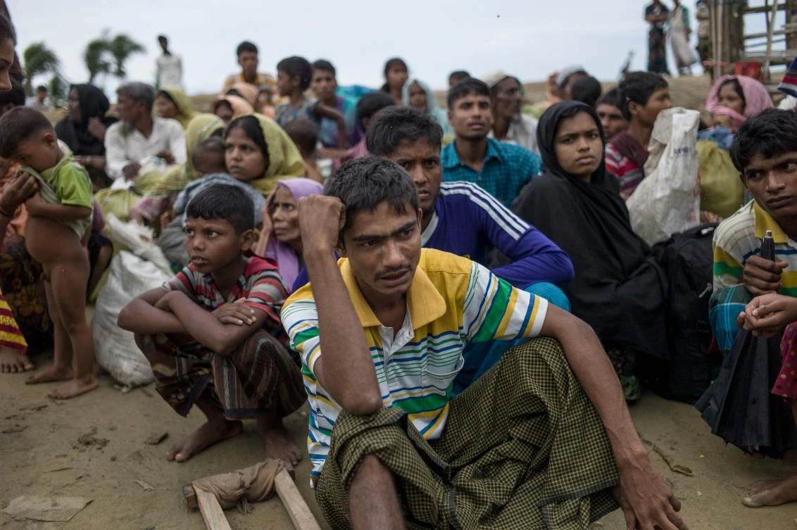 Rohingya Muslim refugees wait to be escorted by Bangladeshi coast guards after crossing the border from Myanmar at the Bangladeshi shores of the Naf river in Teknaf on October 5, 2017. More than half a million Rohingya have fled ethnic bloodshed in Rakhine since late August, many by boat across the Naf River which divides Myanmar and Bangladesh. (AFP)