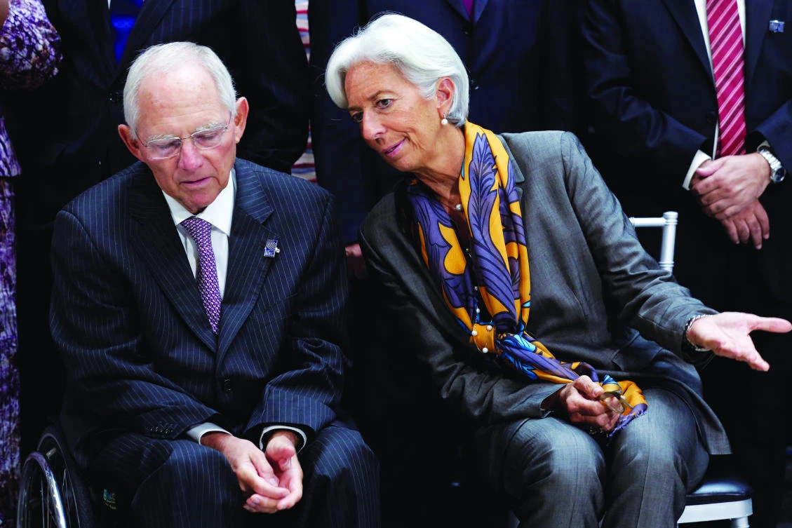 IMF Managing Director Christine Lagarde talks to German Finance Minister Wolfgang Schaeuble before IMF Governors family photo during the IMF/World Bank annual meetings in Washington. (Reuters)