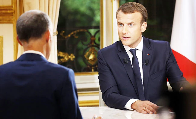 French President Emmanuel Macron speaks during his first interview from the Elysee Palace in Paris, on Sunday. (AFP)
