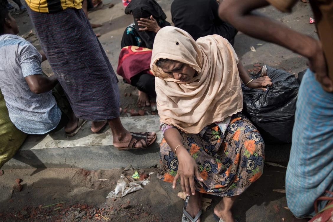 A Rohingya Muslim refugee rests after crossing the border from Myanmar at the Bangladeshi shores of the Naf river in Teknaf on October 5, 2017. (AFP)