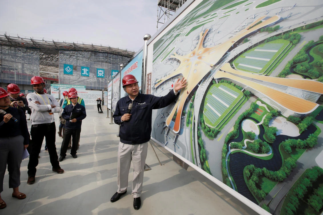 An engineer explains the terminal building to journalists at the construction site of new Daxing Airport on the outskirts of Beijing, China on October 16, 2017. (REUTERS)
