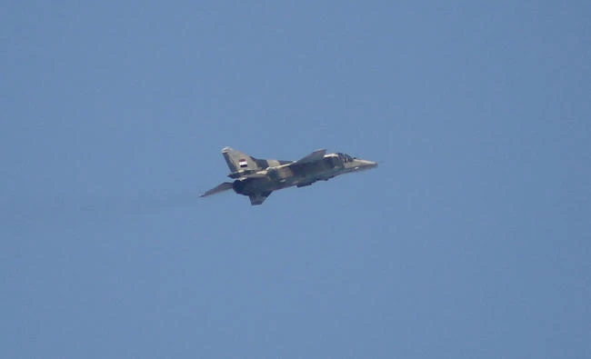 In this file photo, a Syrian government forces MiG-23 "Flogger" fighter plane flying over the city of Ayn Tarma in the Ghouta area, a rebel stronghold east of the Syrian capital Damascus. Israel’s military said on Monday, Oct.16, 2017, it carried out an airstrike on an anti-aircraft battery in Syria. (AFP)