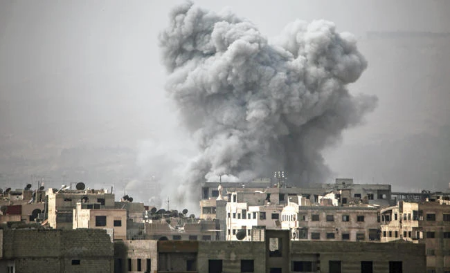 Smoke billows from buildings following a reported air strike on Ain Tarma in the Eastern Ghouta area, an opposition stronghold east of Damascus, on Monday. (AFP)