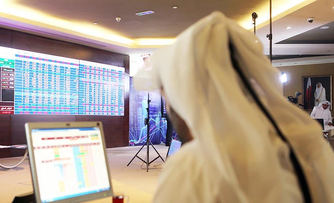 This file photo taken on July 31, 2017 shows a Qatari trader following the stock market at the Qatari stock exchange in Doha. (AFP)