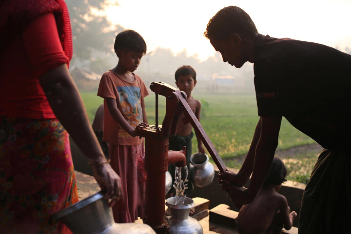 Rohingya refugees collect water from a hand pump near Kutupalong refugee camp in Cox’s Bazar, Bangladesh, on Tuesday, October 3, 2017. (File photo by AP)
