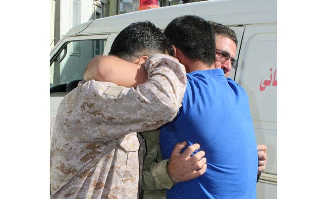 Mourners in Suleimaniyah express grief on Tuesday during a funeral of their relatives — Kurdish Peshmerga fighters — who were killed during an advance by Iraqi forces on Kirkuk. (Reuters)